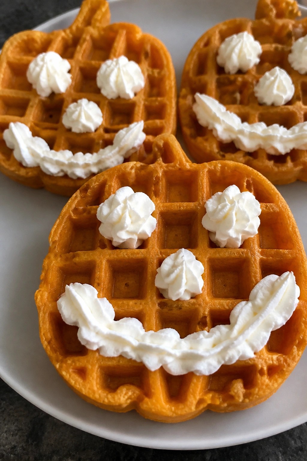 Jack-o'-Lantern Pumpkin Waffles with Whipped Cream