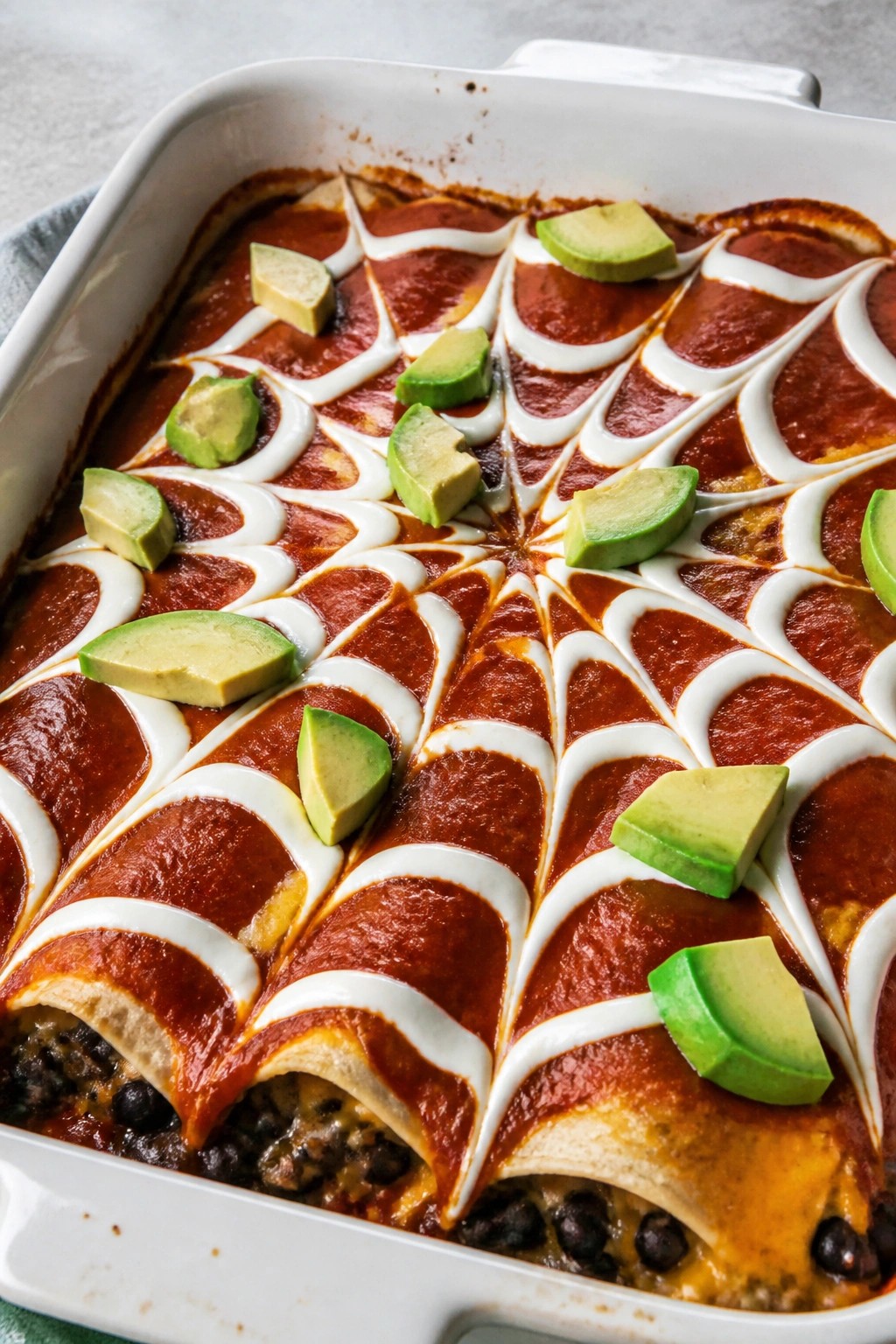 Spiderweb Black Bean Enchiladas with Avocado and Sour Cream