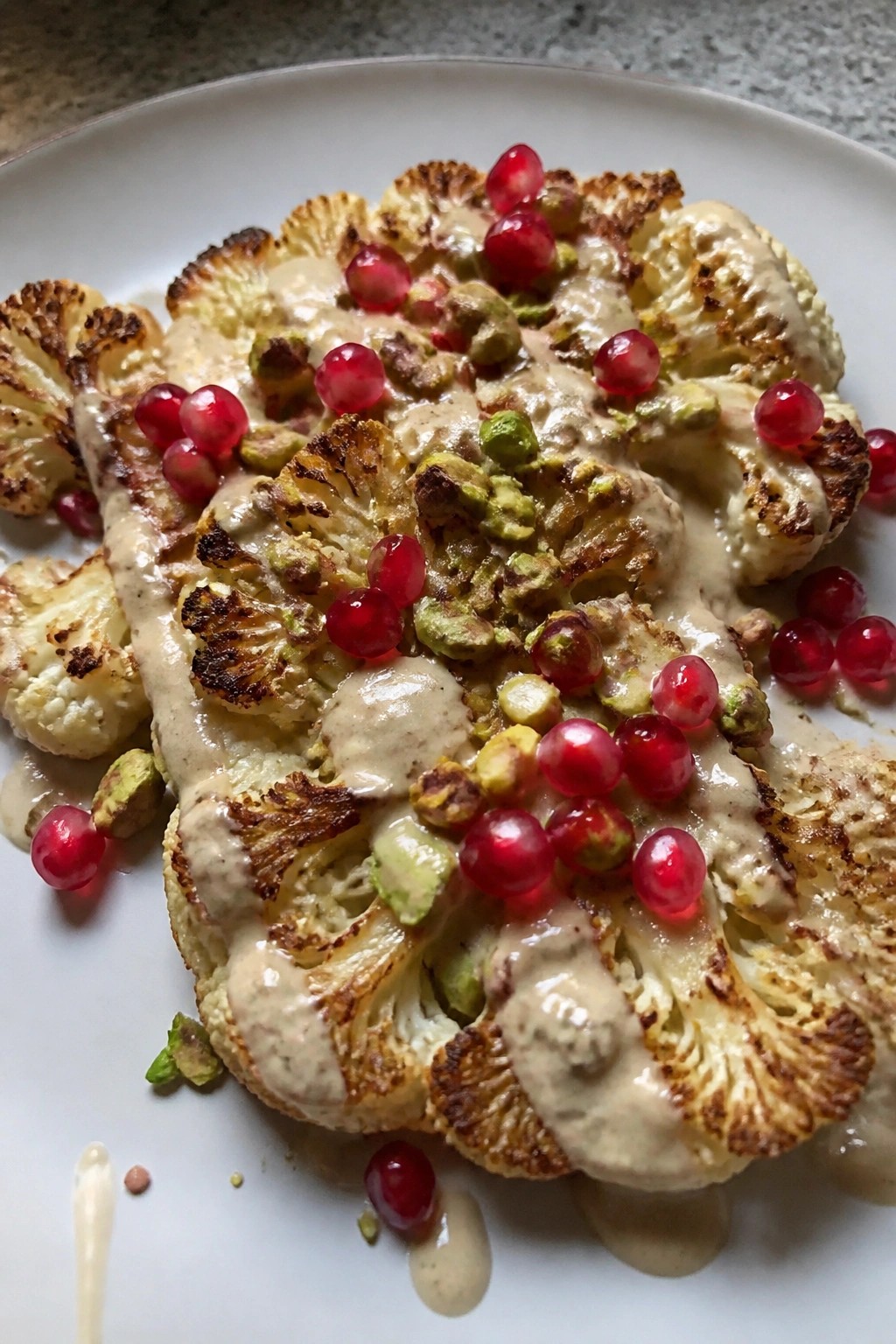 Roasted Cauliflower Steaks with Tahini, Pomegranate, and Pistachio