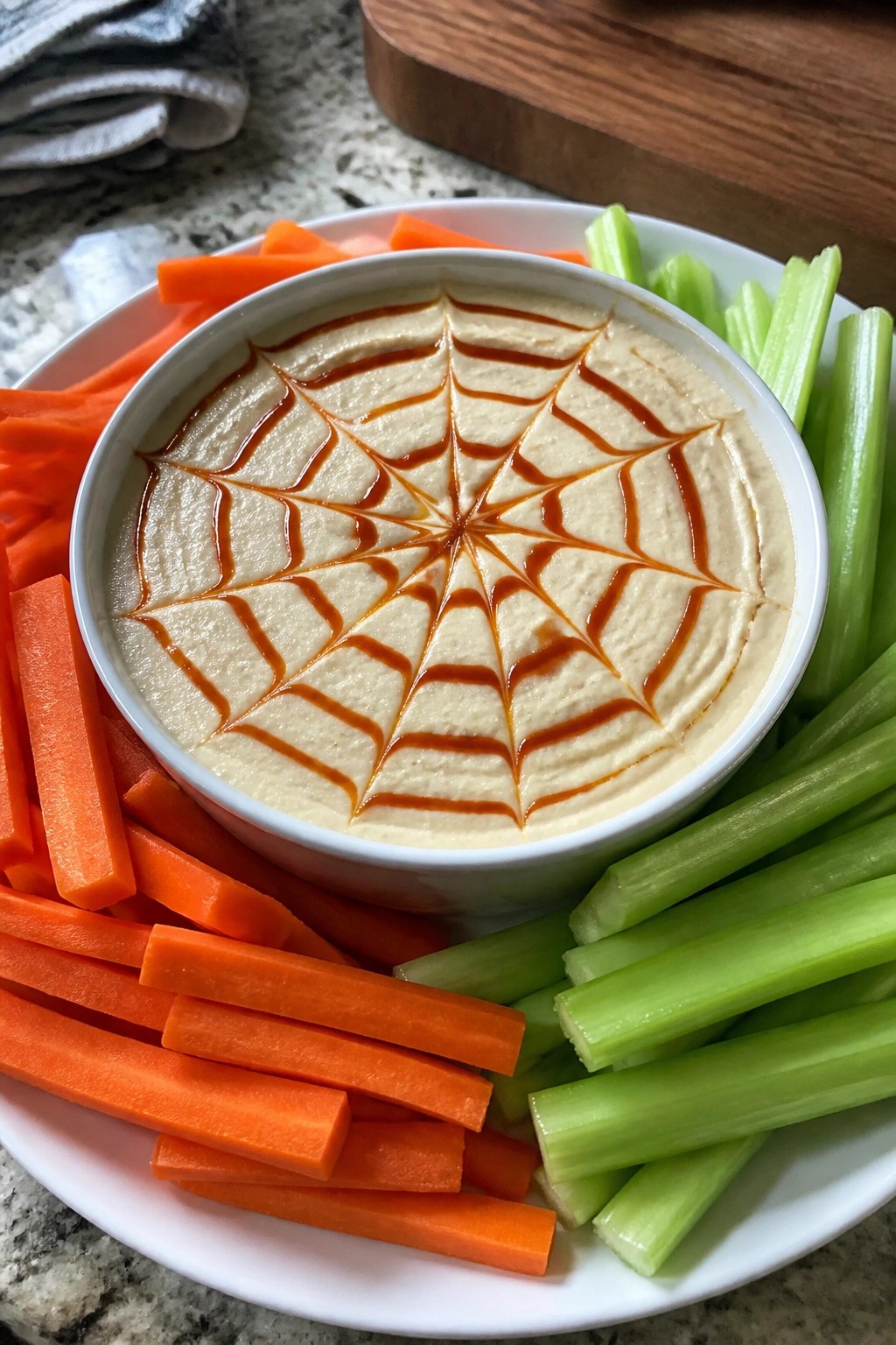 Spiderweb Hummus Platter with Carrot and Celery Dippers