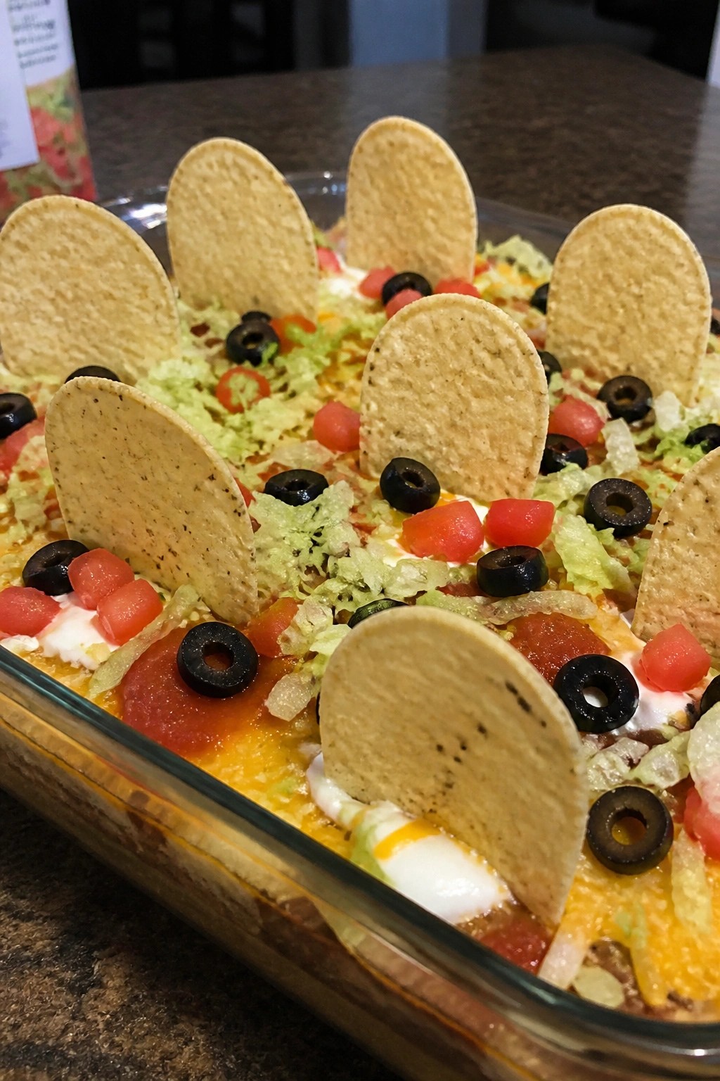 Graveyard Taco Salad Layered Dip with Tortilla Chip Tombstones