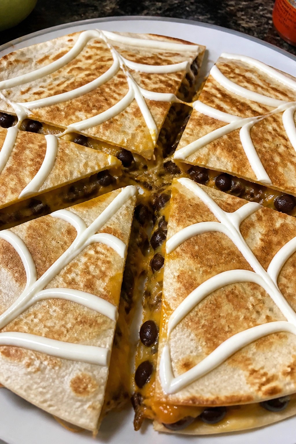 Spiderweb Black Bean Quesadillas with Sour Cream