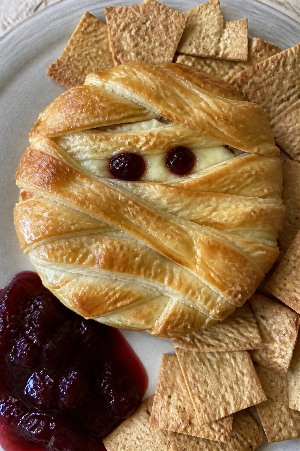 Mummy-Wrapped Brie with Cranberry "Blood" Sauce and Crackers