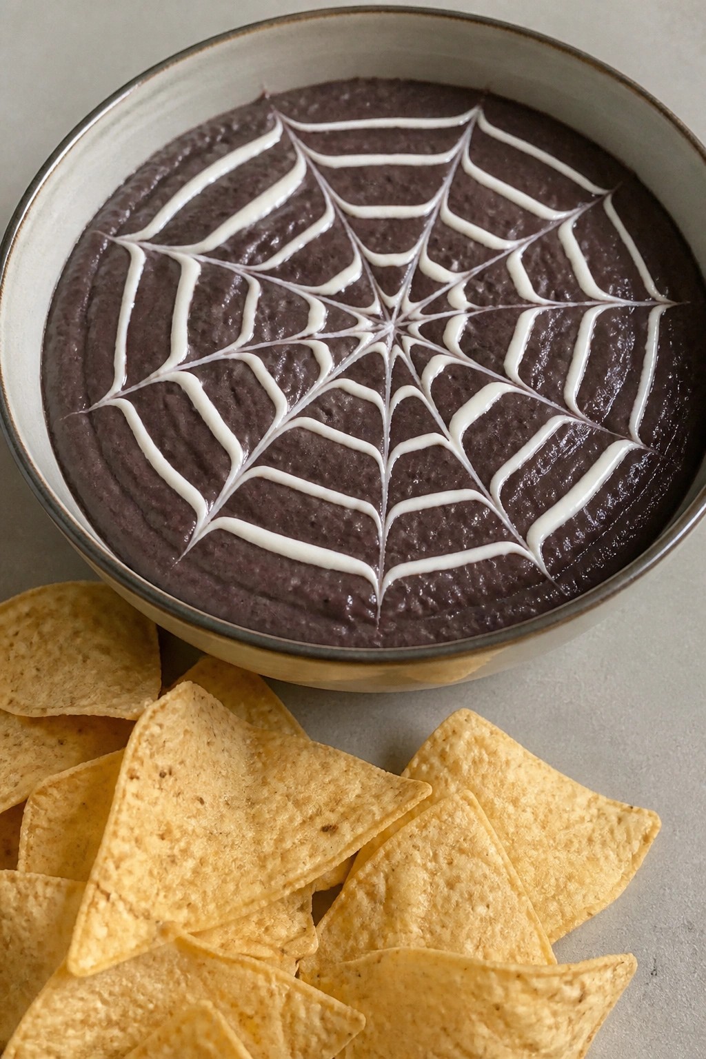 Spiderweb Black Bean Dip with Tortilla Chips