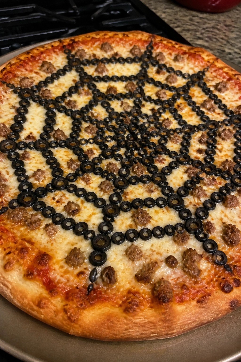 Spiderweb Black Olive and Sausage Pizza