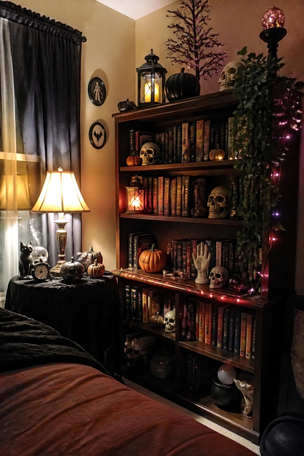 Bedroom with a wooden bookshelf styled with multiple skulls, pumpkins, lanterns, and string lights as the main Halloween display.