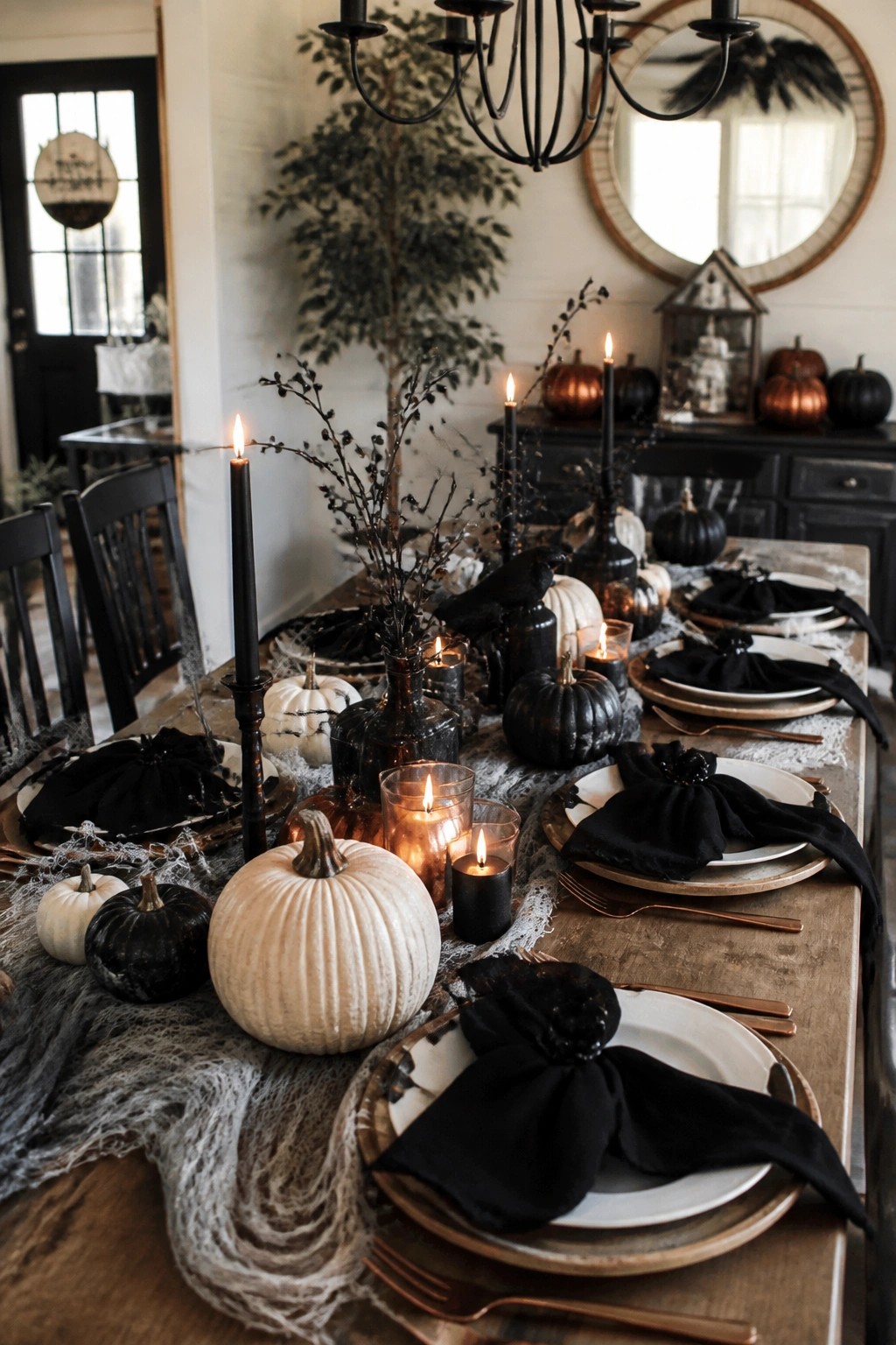 Elegant Halloween table with black candles, pumpkins, napkins, and spiderweb decor on wood.