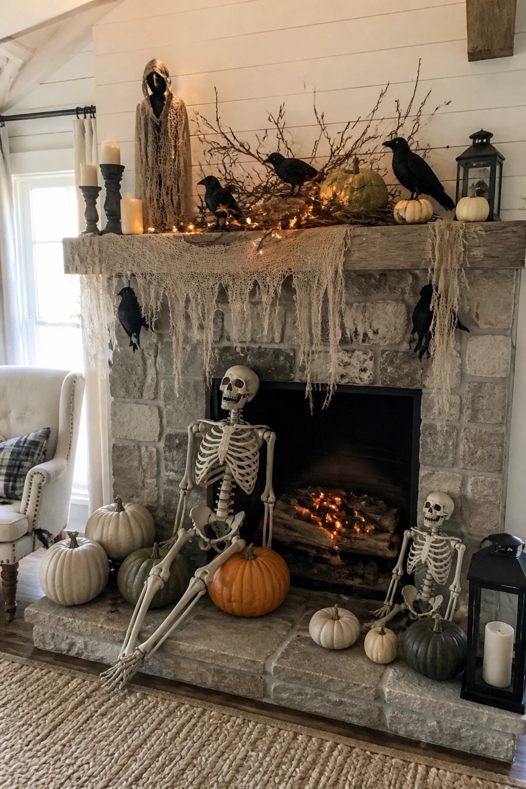 Stone fireplace with two posed skeletons on the hearth, black crows, pumpkins, and gauze draped across the mantel.