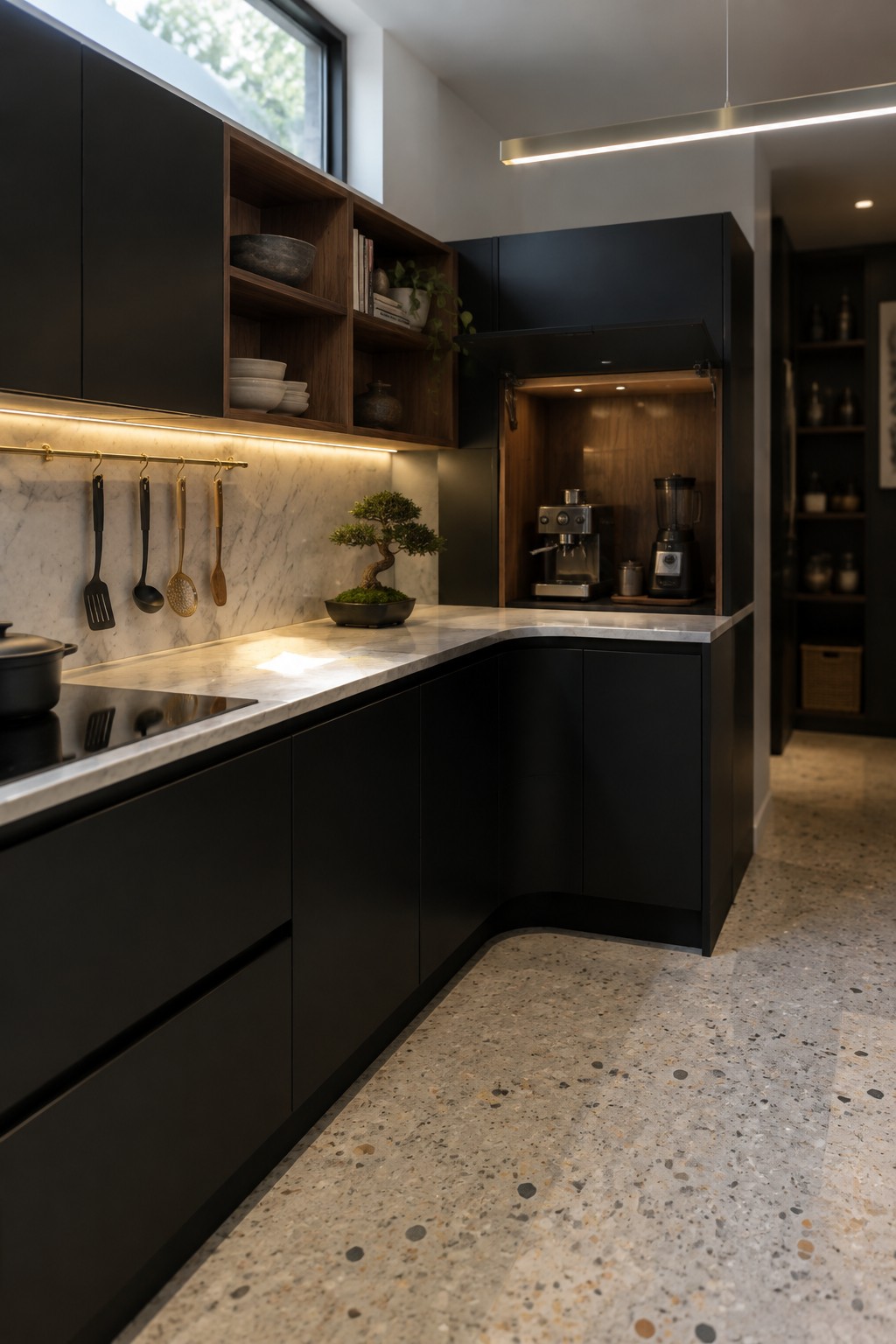 A dark modern kitchen with a lift-up cabinet door open above a counter, revealing a coffee machine and blender.